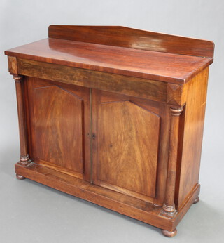 A Georgian mahogany chiffonier with shaped back fitted a drawer above a pair of arched panelled doors, having columns to the sides 105cm h x 117cm w x 47cm d  