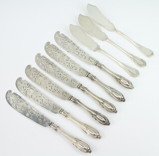 A set of 6 Victorian silver fish knives engraved with dolphins and fish, London 1860 together with 2 Victorian silver fish knives London 1853 