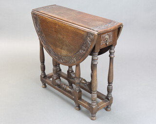 A Victorian carved oak oval drop flap gateleg tea table fitted a frieze drawer, raised on turned and block supports 73cm h x 76cm w x 25cm when closed x 92cm when open 