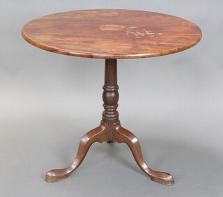A 19th Century circular mahogany snap top tea table raised on a turned column and tripod base 69cm h x 78cm diam.