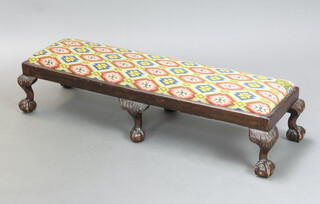 A Georgian style rectangular mahogany footstool with Berlin woolwork drop in seat, raised on carved cabriole, ball and claw supports 24cm h x 105cm w x 33cm d  