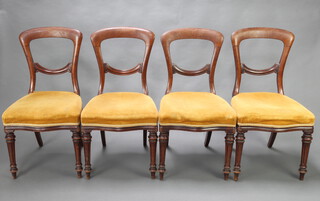 A set of 4 Victorian mahogany spoon back chairs with overstuffed seats of serpentine outline, upholstered in yellow corduroy, raised on turned and fluted supports 89cm h x 46cm w x 45cm d (seat 30cm x 33cm) 