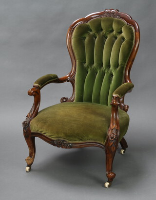 A Victorian mahogany show frame open arm chair upholstered in green button back material 99cm h x 63cm w x 54cm d (inside seat measurement 37 x 42cm)