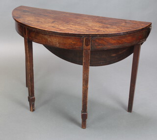 A Georgian mahogany demi-lune drop flap tea table with inlaid satinwood stringing, raised on square tapered supports 70cm h x 104cm w x 44cm when closed x 82cm when open (possibly made up) 