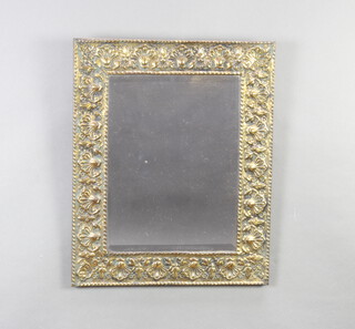 A rectangular bevelled plate mirror contained in an embossed brass frame 53cm x 43cm 