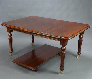 A Victorian style mahogany extending dining table raised on turned and reeded supports, brass caps and casters 76cm h x 110cm w x 157cm l x 208cm l when extended 