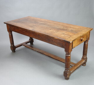 An 18th Century Continental oak refectory table, the top formed of 3 planks, fitted 2 frieze drawers, raised on turned supports with H framed stretcher and bun feet, 73cm h x 168cm l x 73cm w 