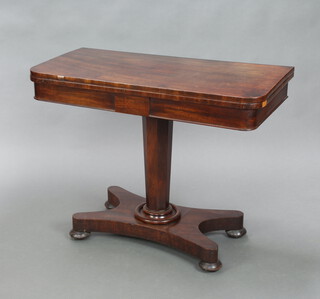A William IV Mahogany card table raised on a chamfered column and triform base with bun feet 72cm h x 91cm w x 46cm d 