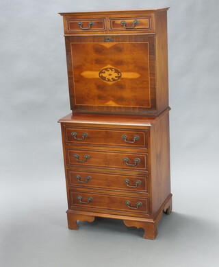 A Georgian style inlaid yew secretaire chest, the upper section with moulded cornice fitted 2 short drawers, the fall front revealing a well fitted interior, the base fitted 4 long drawers, raised on bracket feet 139cm h x 61cm w x 44cm d 