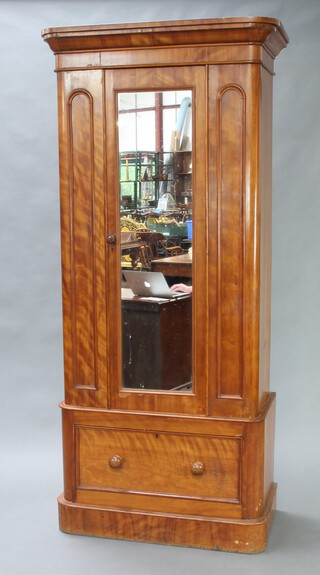 A Victorian bleached mahogany D shaped wardrobe with moulded cornice enclosed by a panelled, mirrored door, the base fitted a drawer, raised on a platform base 205cm h x 49cm w x 93cm d 