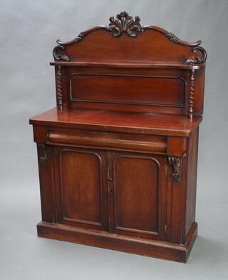 A Victorian mahogany chiffonier with raised back, fitted a shelf, the base with secret drawer above pair of arched panelled doors, raised on a platform base 152cm h x 106cm w x 43cm d