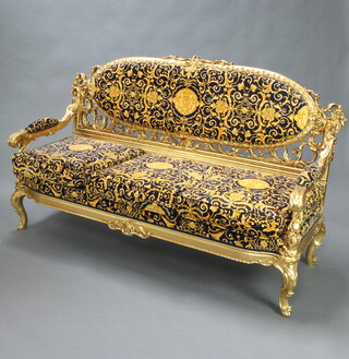 An impressive Louis XVI style pierced gilt plaster wood salon suite comprising 3 seat sofa 105cm h x 173cm w x 66cm d (seat 159cm x 54cm)and 2 open armchairs 99cm h x 73cm w x 62cm d (seat 54cm x 48cm) upholstered in blue and gold fabric
