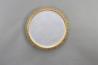 A circular bevelled plate wall mirror contained in decorative pierced gilt frame 47cm 