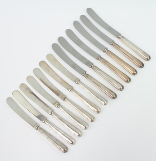 A set of 6 silver handled ribbon and bow butter knives