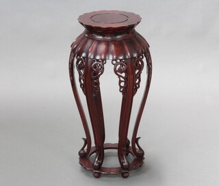 A circular Chinese hardwood jardiniere stand raised on 6 panel supports 62cm x 23cm 