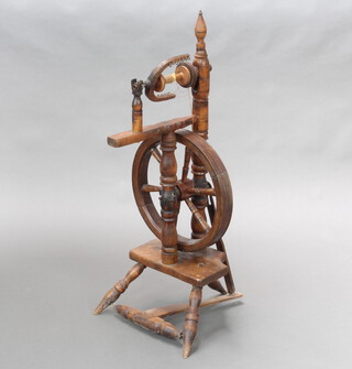 An 18th/19th Century turned beech spinning wheel 195cm h x 40cm w x 39cm d 
