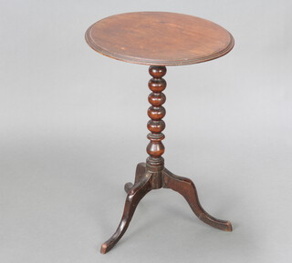 A Victorian circular mahogany wine table, raised on a pillar and tripod base 62cm h x 42cm diam. 
