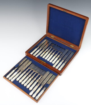 A mahogany canteen containing a set of 6 pairs of silver plated dessert eaters with carved lily pattern mother of pearl handles 