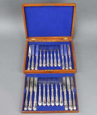 A mahogany canteen containing a set of 6 silver plated lily pattern dessert eaters, a similar set of 6 