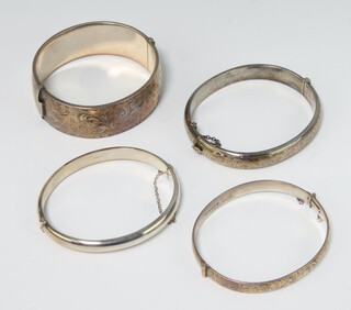 A silver chased bangle, 3 others, gross weight 110 grams