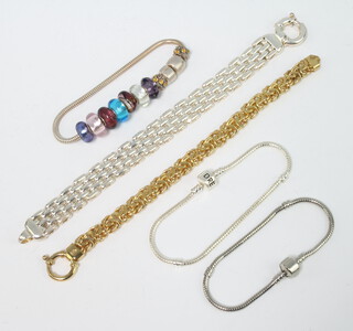 A silver bracelet, a silver gilt ditto and 2 others 