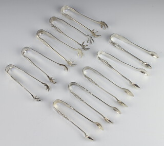 Ten pairs of silver plated lily pattern sugar tongs 