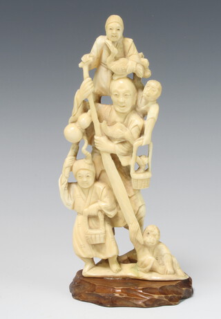 A Japanese ivory Meiji period Okimono depicting a street seller with children, monkey and birds, raised on a carved wooden base 19cm 
