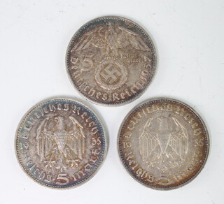 Two German 1935 five mark coins together with a ditto 1937 