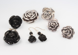 A 925 standard Italian silver pendant in the form of a rose, ditto ring and pair of earrings, 2.58 grams together with a similar 925 pendant with cut black glass rose, ring and earrings 