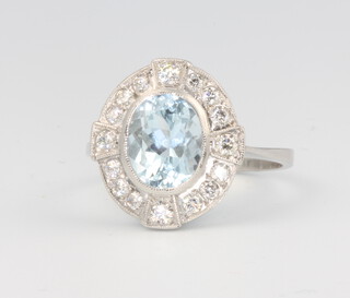 A platinum Edwardian style oval aquamarine and diamond cluster ring, the centre stone approx 1.7ct surrounded by brilliant cut diamonds approx. 0.5ct, 5.1 grams, size L 