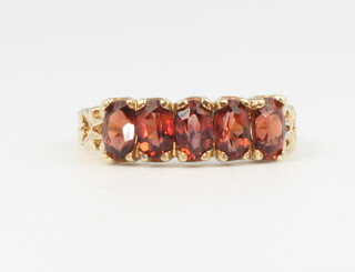 A 9ct yellow gold 5 stone garnet ring, size J 1/2, 2.6 grams