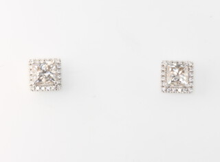 A pair of 18ct white gold princess cut halo diamond studs, the princess cut diamonds approx. 1.95ct, the diamond halos 0.15ct