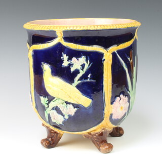 A Minton style Victorian jardiniere, the blue ground decorated with panels of birds and flowers, raised on rustic feet 25cm 