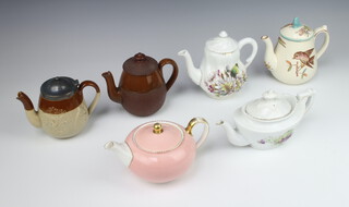 An Edwardian teapot decorated with birds 13cm, a silver rimmed teapot and 4 other small teapots 