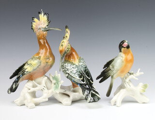 Karl Ens, a German figure of a bird standing on a trunk 17cm together with a pair of exotic birds sitting on a branch 26cm