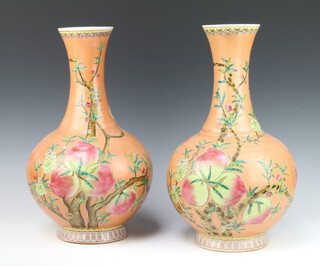 A pair of Antique style peach ground baluster vases decorated with fruits, 6 character mark to the base 40cm h