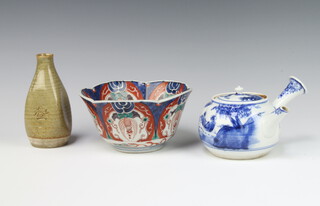 A Japanese slip glazed vase with incised decoration 12cm, an Imari bowl (worn) and a Saki pot 
