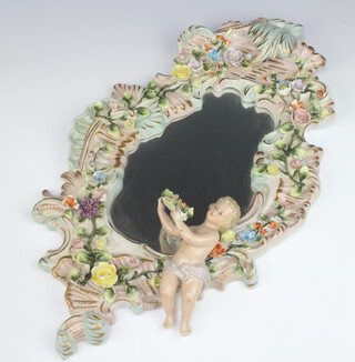 A 20th Century German porcelain Rococo style wall mirror with bevelled plate, surmounted by an angel and applied flowers 45cm 