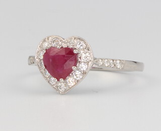 A platinum Edwardian style heart cut ruby and diamond cluster ring, the centre stone approx. 1.05ct surrounded by brilliant cut diamonds approx. 0.25ct, 3.4 grams, size L 1/2