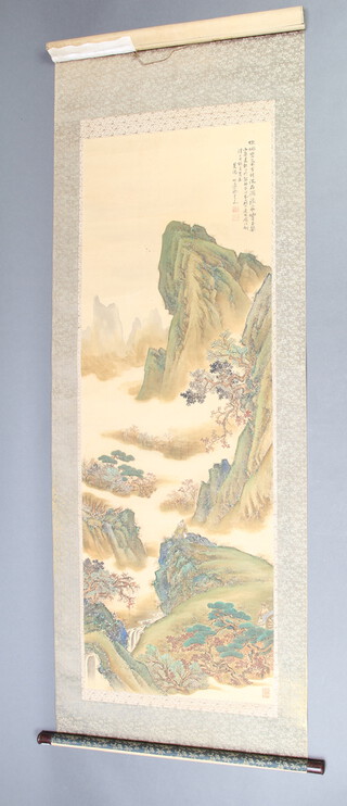 An early 20th Century Chinese scroll work painting depicting a seated figure in an extensive landscape with script and seal mark 154cm x 53cm 