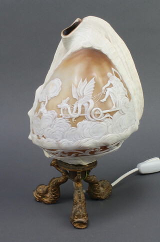 A Victorian carved conch shell decorated Old Father Time, raised on dolphin gilt metal supports 28cm h x 17cm w x 13cm d (converted to a table lamp) 