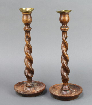 A pair of 1930's oak spiral turned candlesticks with detachable brass sconces 31cm h x 12cm diam. 