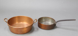 A circular copper saucepan with iron handle marked 26 8cm x 26cm together with a circular copper twin handled preserving pan 12cm x 37cm 
