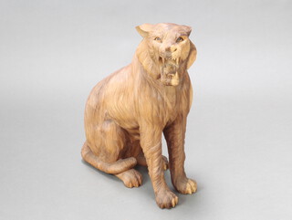 A carved hardwood figure of a seated tiger 54cm h x 43cm w x 16cm d 
