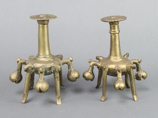 A pair of curious Eastern bronze candlesticks 13cm x 9cm 