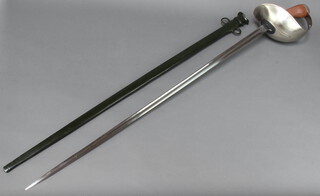 A 1908 pattern Cavalry Troopers sword with unmarked blade contained in a green scabbard