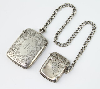 A Victorian silver vesta Birmingham 1876, an Edwardian ditto Birmingham 1908 and a silver Albert, 60 grams