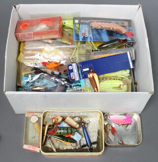 A collection of vintage fishing lures including a boxed Heddon box lure, a Bill Norman box lure, an Abu and others 