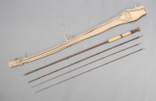 An early Foster of Kelso 10'6" split cane fly fishing rod with 2 tips, contained in a brown cloth bag 