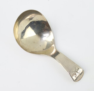 A William IV silver caddy spoon of plain form and engraved monogram, London 1833, 10 grams